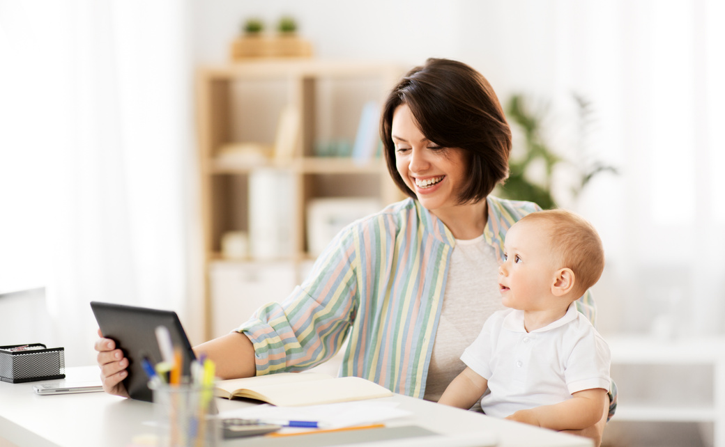 Working Mother with Tablet Pc and Baby at Home